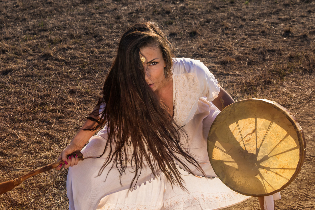 Shaman woman drumming